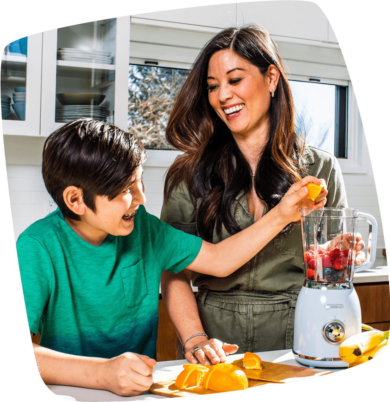 Photo of Mom and son making a smoothie with organic fruits